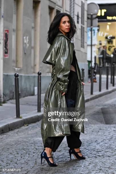 Rim ML is seen wearing a forest green Frankie Shop trench coat, black crop top, black and blue Frankie Shop pants during the Womenswear Spring/Summer...