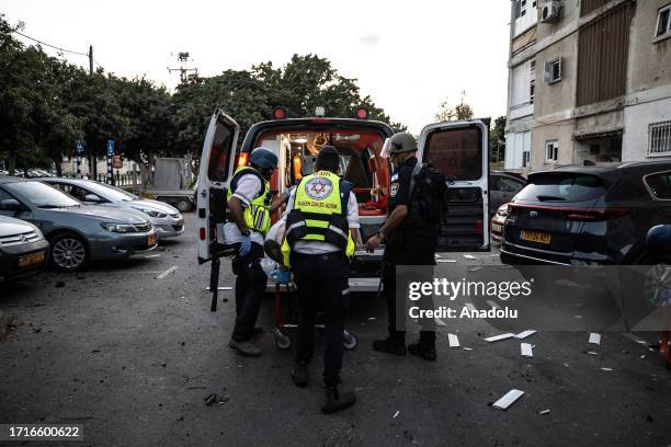 Injured people are transferred to hospitals after rockets launched by Palestinians into Israel's Ashkelon city as clashes continue between Israeli...