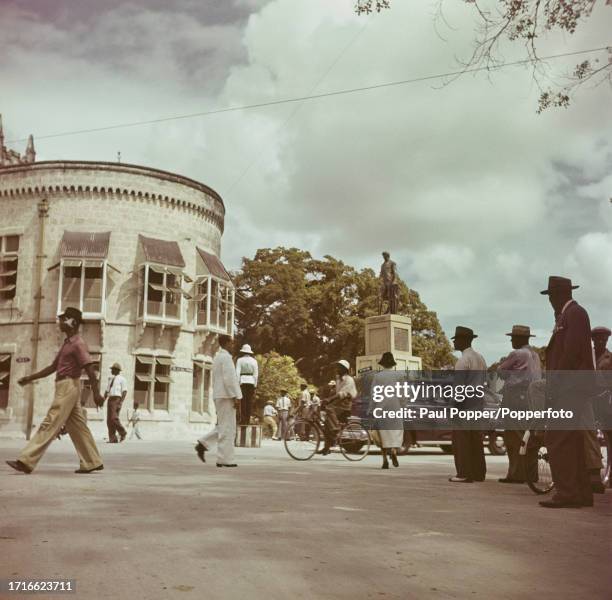Pedestrians pass the bronze statue of Lord Nelson in Trafalgar Square in the centre of the city of Bridgetown, capital of Barbados in the West Indies...