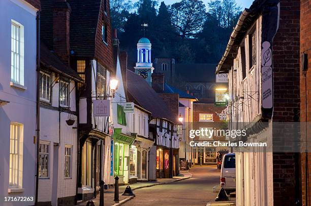 traditional street in godalming is lit at dusk - surrey stock pictures, royalty-free photos & images