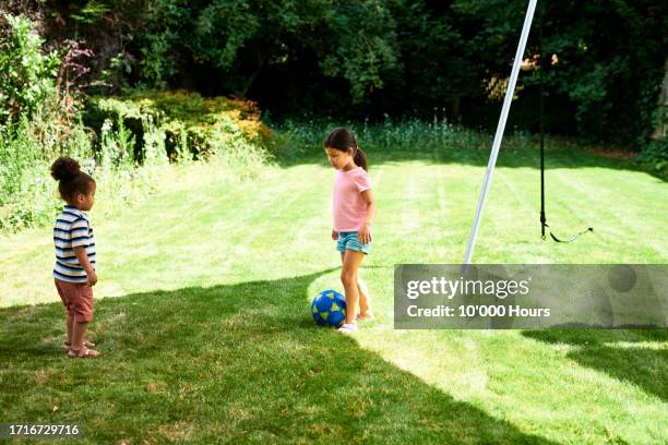 boy and girl playing with ball in garden - championship day two stock pictures, royalty-free photos & images