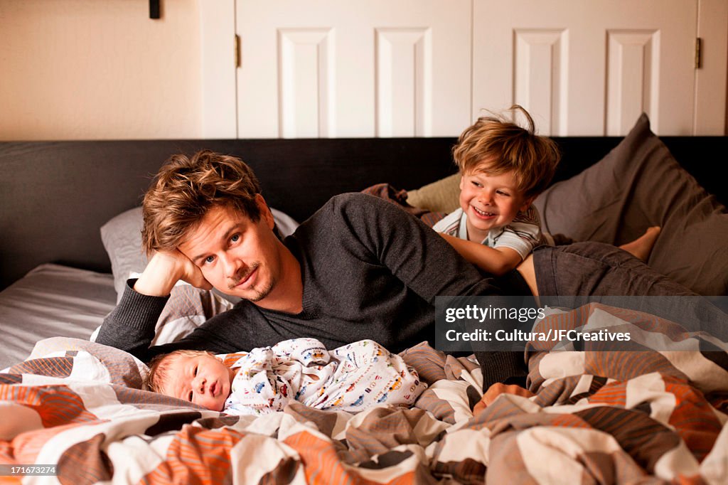 Father, son and newborn baby