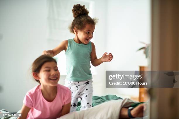 brother and sister giggling and waking up parents - kids adults stock pictures, royalty-free photos & images