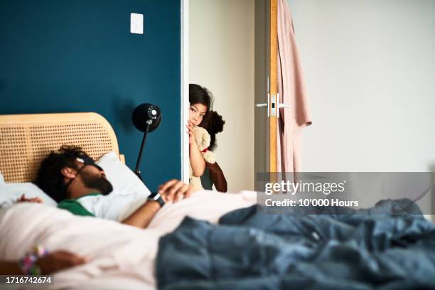 young child peeking round bedroom door, parents asleep - awake day stock pictures, royalty-free photos & images