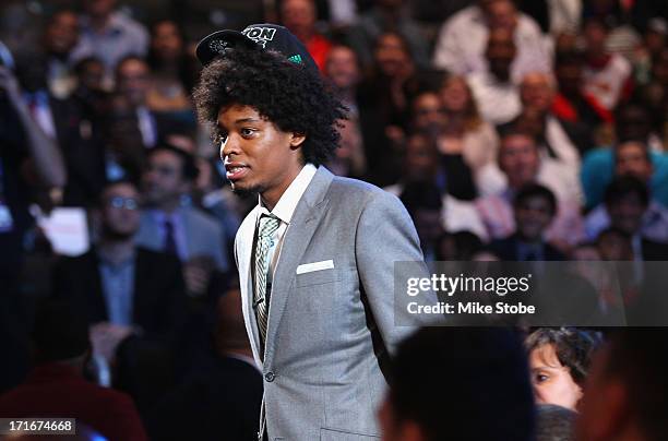 Lucas Bebe Nogueira of Brazil walks through the green room towards the stage after he was drafted overall in the first round by the Boston Celtics...