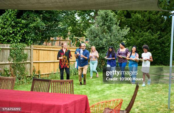 multi racial group of family friends pitching in and helping out, preparing for garden party - 12 year old indian girl stock pictures, royalty-free photos & images