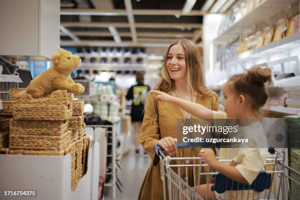 happy mother having fun with his daughter - woman picking up toys stock pictures, royalty-free photos & images