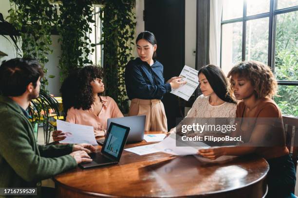 business meeting of young adult people in a modern loft - marketing director stock pictures, royalty-free photos & images