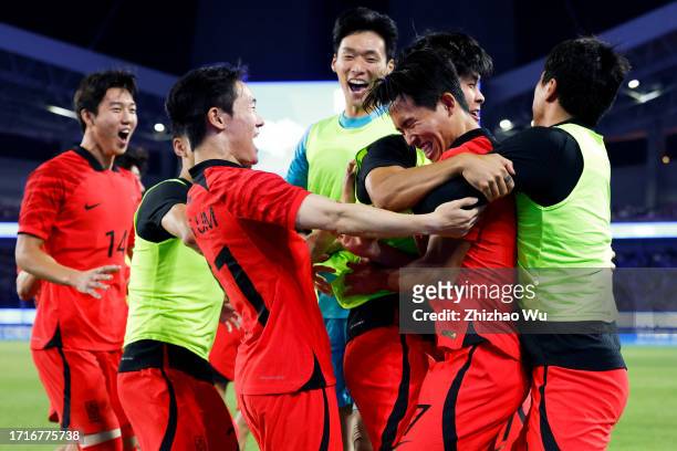 Jeong Wooyeongn of South Korea celebrates his first goal with teammatesduring the 19th Asian Game Men's Semifinal between South Korea and Uzbekistan...