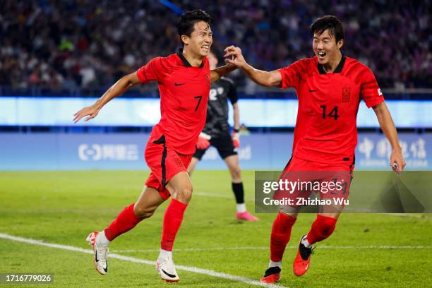 Jeong Wooyeongn of South Korea celebrates his second goal with teammates during the 19th Asian Game Men's Semifinal between South Korea and...