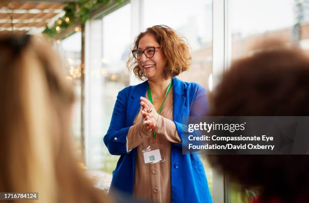 asian businesswoman talking at women's seminar - conference stock pictures, royalty-free photos & images