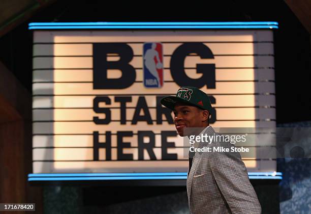 Giannis Antetokounmpo of Greece walks on stage after Antetokounmpo was drafted overall in the first round by the Milwaukee Bucks during the 2013 NBA...