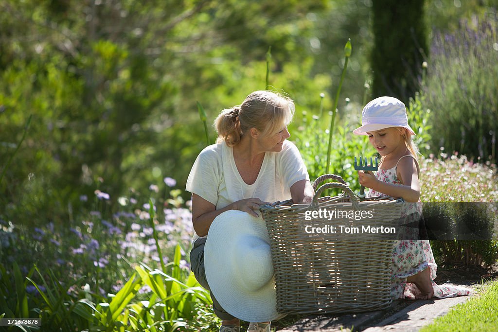 Grandmother and granddaughter looking in basket 