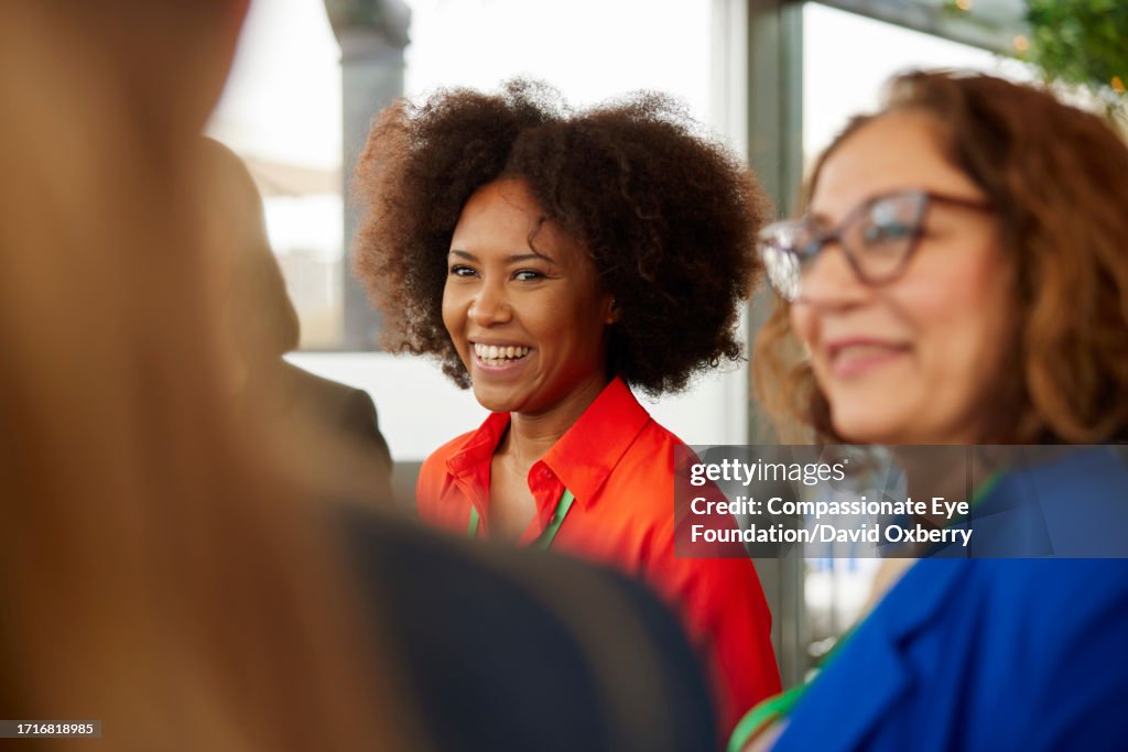 Businesswomen talking at networking event