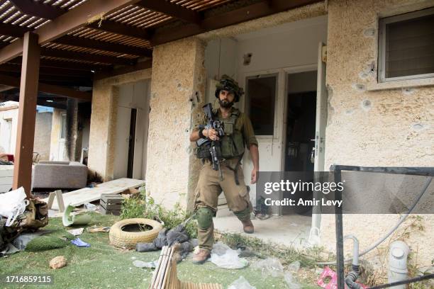 An Israeli soldier exits a destroyed house after an attack by Palestinian militants on takibbutz near the border with Gaza on October 10, 2023 in...