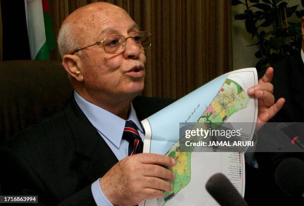 Palestinian Prime Minister Ahmed Qorei shows a map of Gaza Strip during a press conference in the West Bank city of Ramallah, 21 July 2005. Qorei...