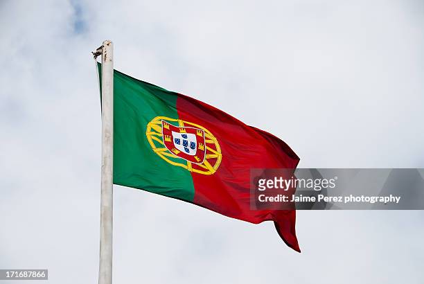 portuguese flag waving in the wind - portuguese flag stock pictures, royalty-free photos & images