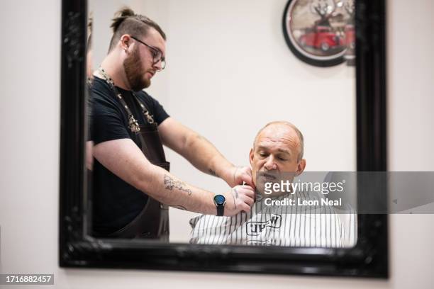Liberal Democrat Party leader Ed Davey receives a trim from stylist Bayley McNamee at Route 66 Barbers during a by-election campaign visit on October...