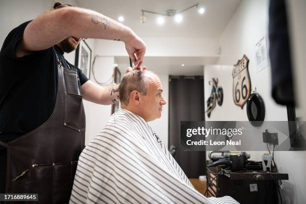 Liberal Democrat Party leader Ed Davey receives a trim from stylist Bayley McNamee at Route 66 Barbers during a by-election campaign visit on October...