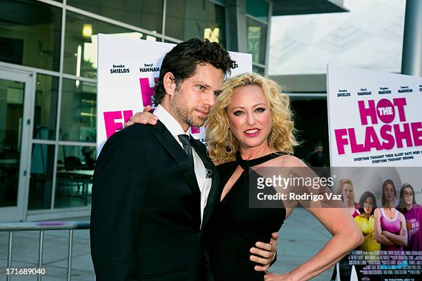 Actors Nick Holmes and Virginia Madsen arrive at "The Hot Flashes" Los Angeles premiere at ArcLight Cinemas on June 27, 2013 in Hollywood, California.