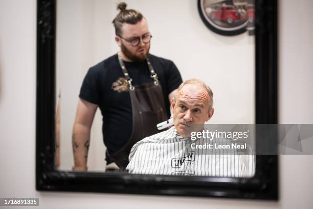 Liberal Democrat Party leader Ed Davey receives a trim from stylist Bayley McNamee at Route 66 Barbers during a by-election campaign visit on October...