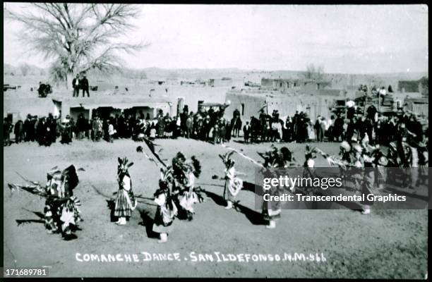 Ceremonial dance of the Comanche is depicted in this postcard shot around 1910 in San Ildefonso, New Mexico.