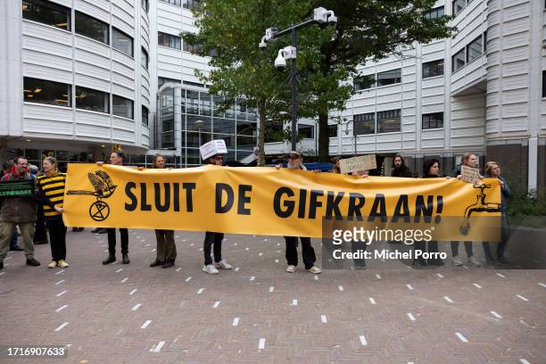 Protesters holding a banner reading 'Close the poison tap' stand outside parliament on October 4, 2023 in The Hague, Netherlands. Demonstrators...