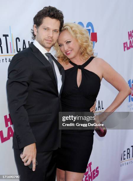 Actors Virginia Madsen and Nick Holmes arrive at the Los Angeles premiere of "The Hot Flashes" at ArcLight Cinemas on June 27, 2013 in Hollywood,...