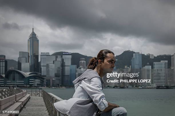 To go with HongKong-Asia-immigration-refugee,FEATURE This picture taken on June 26, 2013 shows Bangladeshi refugee Nazmul Huda sitting in front of...