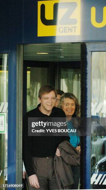Belgian Prime Minister Guy Verhofstadt flanked by his wife Dominique Verkinderen smiles as he gets out of Ghent university hospital, 01 April 2005...