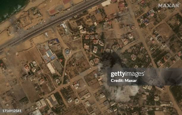 Maxar satellite imagery of a large explosion and smoke from airstrike . Please use: Satellite image 2023 Maxar Technologies.