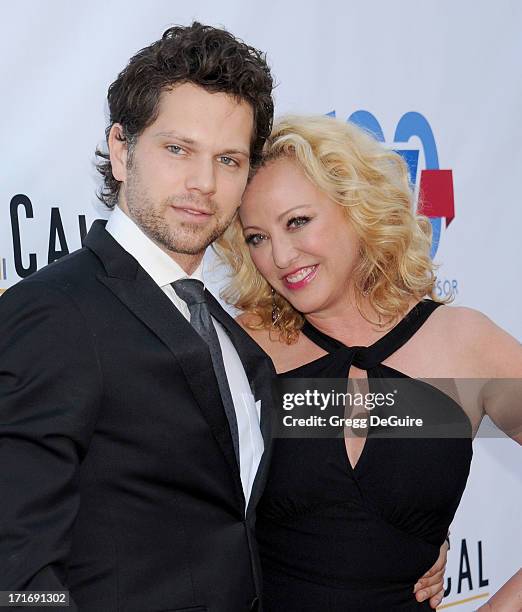 Actors Virginia Madsen and Nick Holmes arrive at the Los Angeles premiere of "The Hot Flashes" at ArcLight Cinemas on June 27, 2013 in Hollywood,...