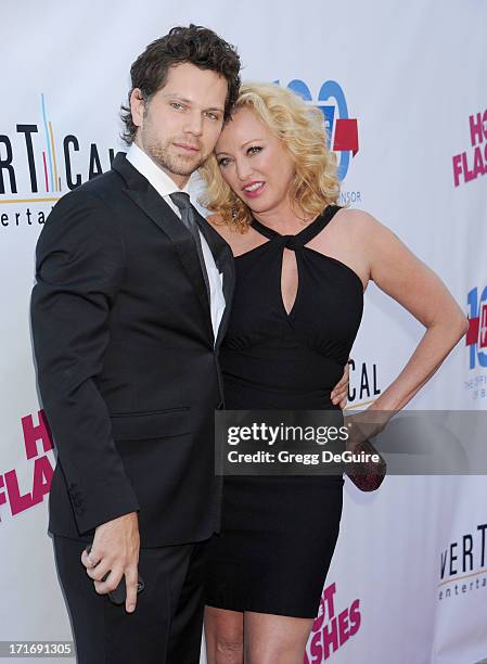 Actors Virginia Madsen and Nick Holmes arrive at the Los Angeles premiere of "The Hot Flashes" at ArcLight Cinemas on June 27, 2013 in Hollywood,...