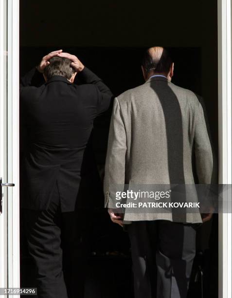 British Prime Minister Tony Blair and French President Jacques Chirac arrive for the first working session of a G8 meeting 07 July 2005, at...