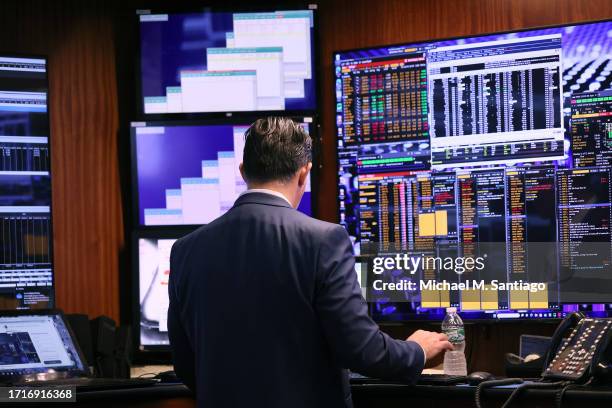 Traders work on the floor of the New York Stock Exchange during morning trading on October 04, 2023 in New York City. The market opened up slightly...