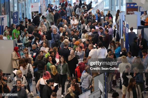 People, including many Ukrainians, attend a jobs fair for migrants and refugees on October 04, 2023 in Berlin, Germany. The German government is...