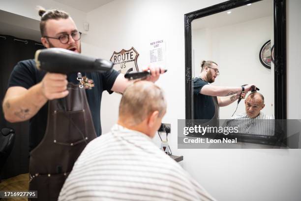 Liberal Democrat Party leader Ed Davey receives a trim from stylist Bayley McNamee at Route 66 Barbers during a by-election campaign visit on October...