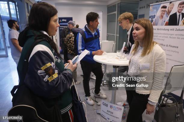 Olga Kramar , who has been living in Berlin for a year and a half after fleeing war in her native Ukraine, speaks with a Russian-speaking stand...