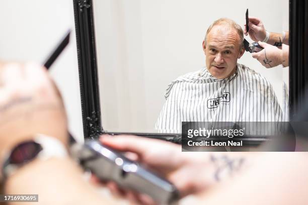 Liberal Democrat Party leader Ed Davey receives a trim from stylist Bayley McNamee at Route 66 Barbers during a by-election campaign visit on October...