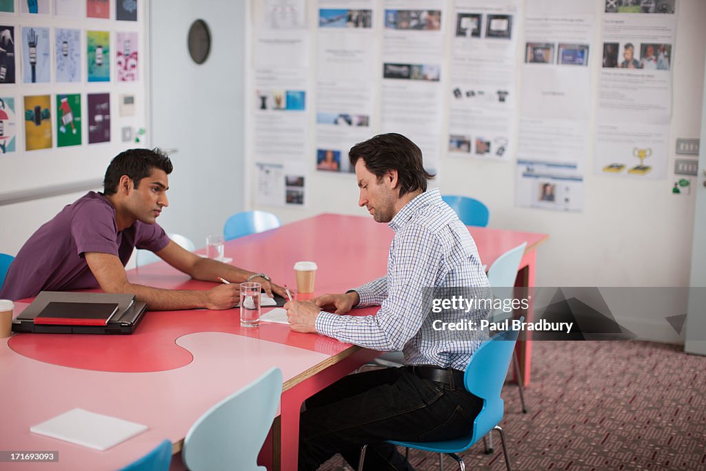 Men talking in meeting