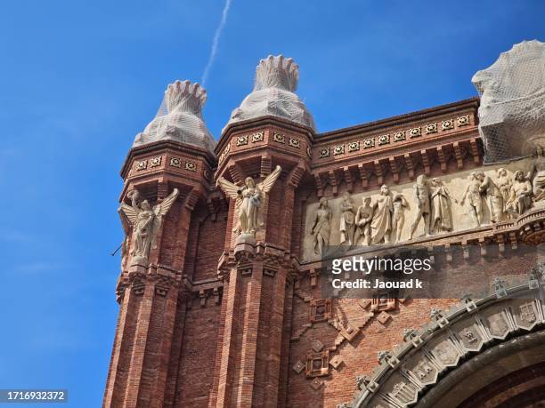 view of arc de triomf against blue sky, barcelona, spain - torre agbar stock pictures, royalty-free photos & images