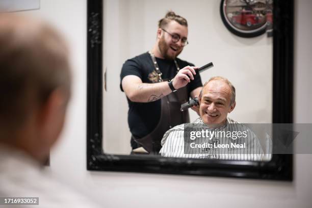 Liberal Democrat Party leader Ed Davey receives a trim from stylist Bayley McNamee at Route 66 Barbers during a by-election campaign visit on October...