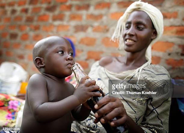 Mother giving her child Coca Cola to drink pictured on May 31, 2013 in Kabunyata, Uganda.