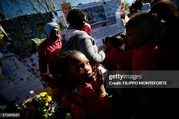 Children stand in front of messages left for Nelson Mandela outside the Medi Clinic Heart hospital in Pretoria on June 28, 2013. A gravely ill Nelson...