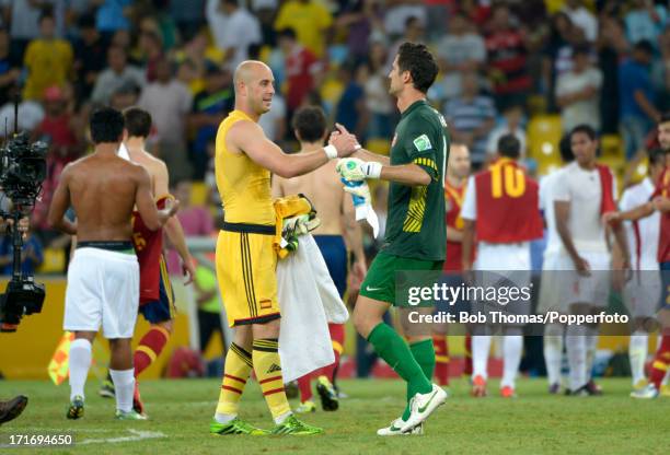 Tahiti goalkeeper Mikael Roche, who conceded 10 goals in the match, shakes hands with Spanish goalkeeper Pepe Reina after the FIFA Confederations Cup...