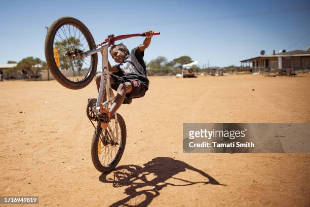 Young child does a Wheelie on his bicycle on October 04, 2023 in Pia Wadjarri, Australia. A referendum for Australians to decide on an indigenous...