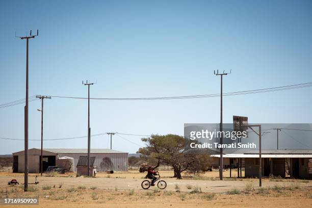 Young child rides his bike on the basketball court which is the center of the community on October 04, 2023 in Pia Wadjarri, Australia. A referendum...