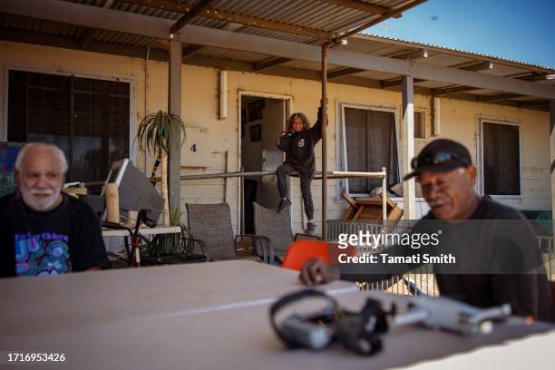 Young boy sits on the railing at the front door of one of the houses in the community on October 04, 2023 in Pia Wadjarri, Australia. A referendum...