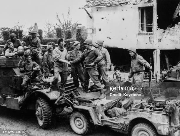 Soldiers from the 1st Polish Armored Divsion attached to First Canadian Army link up with American troops from the 90th Infantry Division of the...