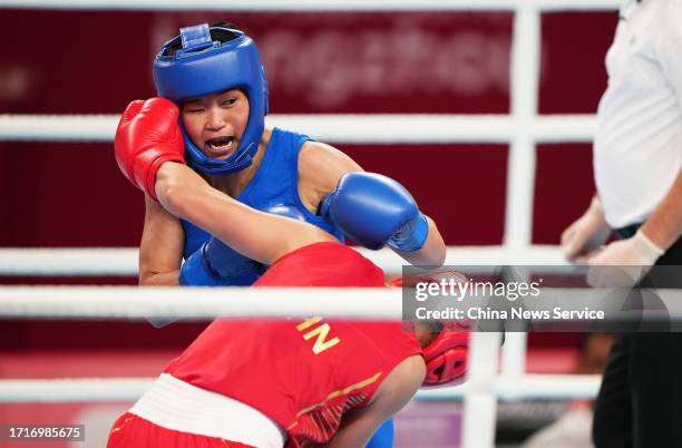 Pang Cholmi of Team DPR Korea competes against Chang Yuan of Team China in the Boxing - Women's 50-54Kg Final on day 11 of the 19th Asian Games at...